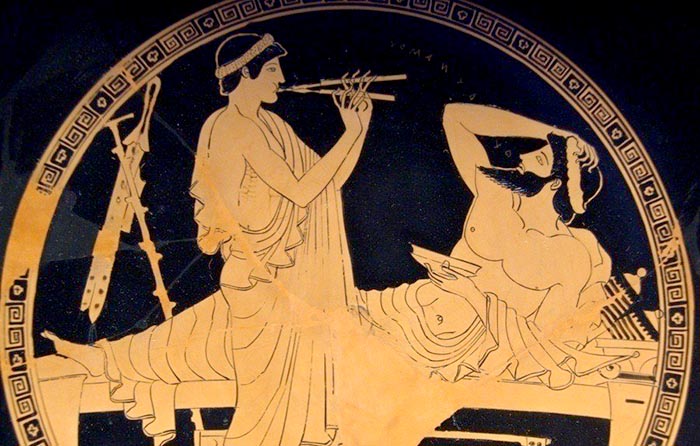 A symposium scene on a 5th century BCE Greek cup