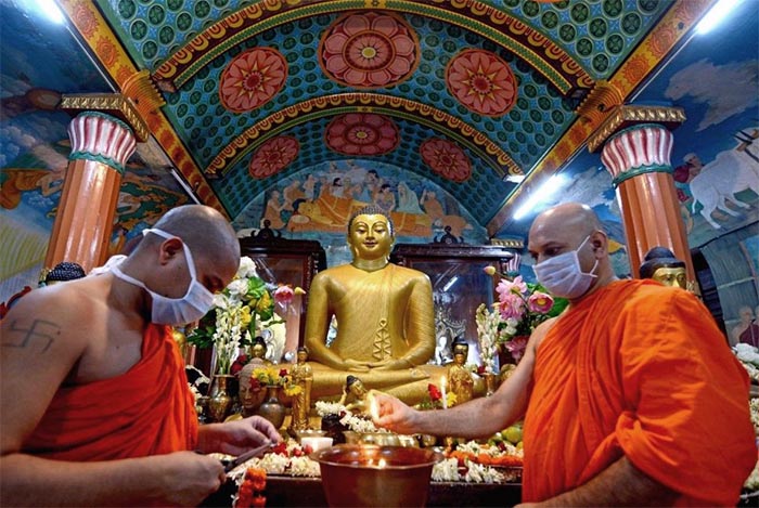 priests performing rituals at a Buddhist temple in Calcutta 