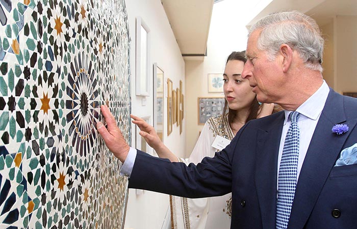The Prince of Wales speaks with artist Dana Awartani as he looks at her artwork