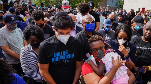 Dallas Texas. Following the death of George Floyd on 25 May, Dallas Mavericks owner Mark Cuban stands with Rev. Stacey Brown and Dallas Police Chief Rene Hall (right) as they gather in prayer to ask for justice against racism.
