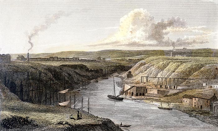 The Wear Above Sunderland Iron Bridge, c1829. The Wear was an important waterway for the export of the coal, chemical and industrial products of the area. On the right are warehouses and staithes, while on the left are the tops of the masts of vessels whi
