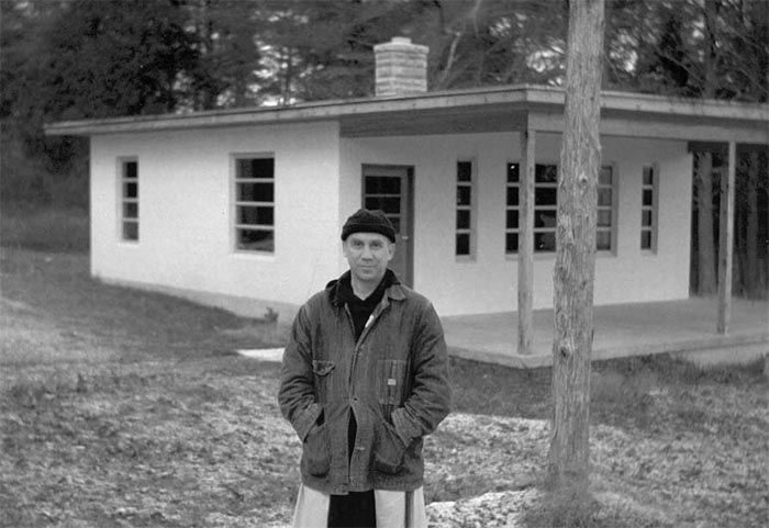 Merton in front of a cottage