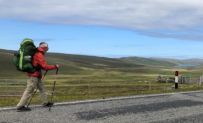 Munekan Masha 1 Offerings 700 Richard Gault walking on a street in rural Scotland